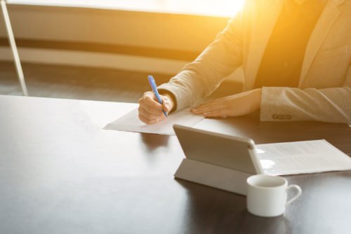 woman signing document