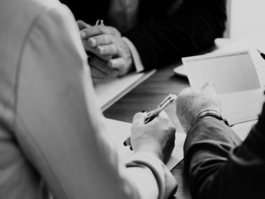 people signing papers