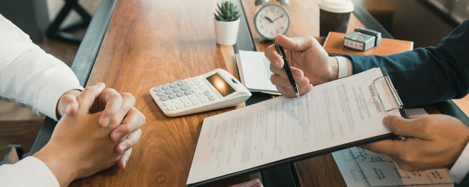 agents are using pens pointing to contracts 